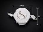 Enroulo blanc avec câble USB, dimensions indiquées : 7,4 cm de large et 7,6 cm de haut